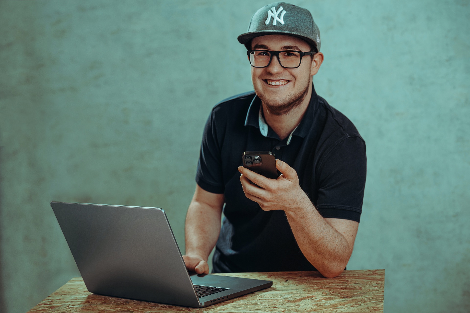 Tobias Gerhartz von TG IT-Service mit Laptop und Smartphone